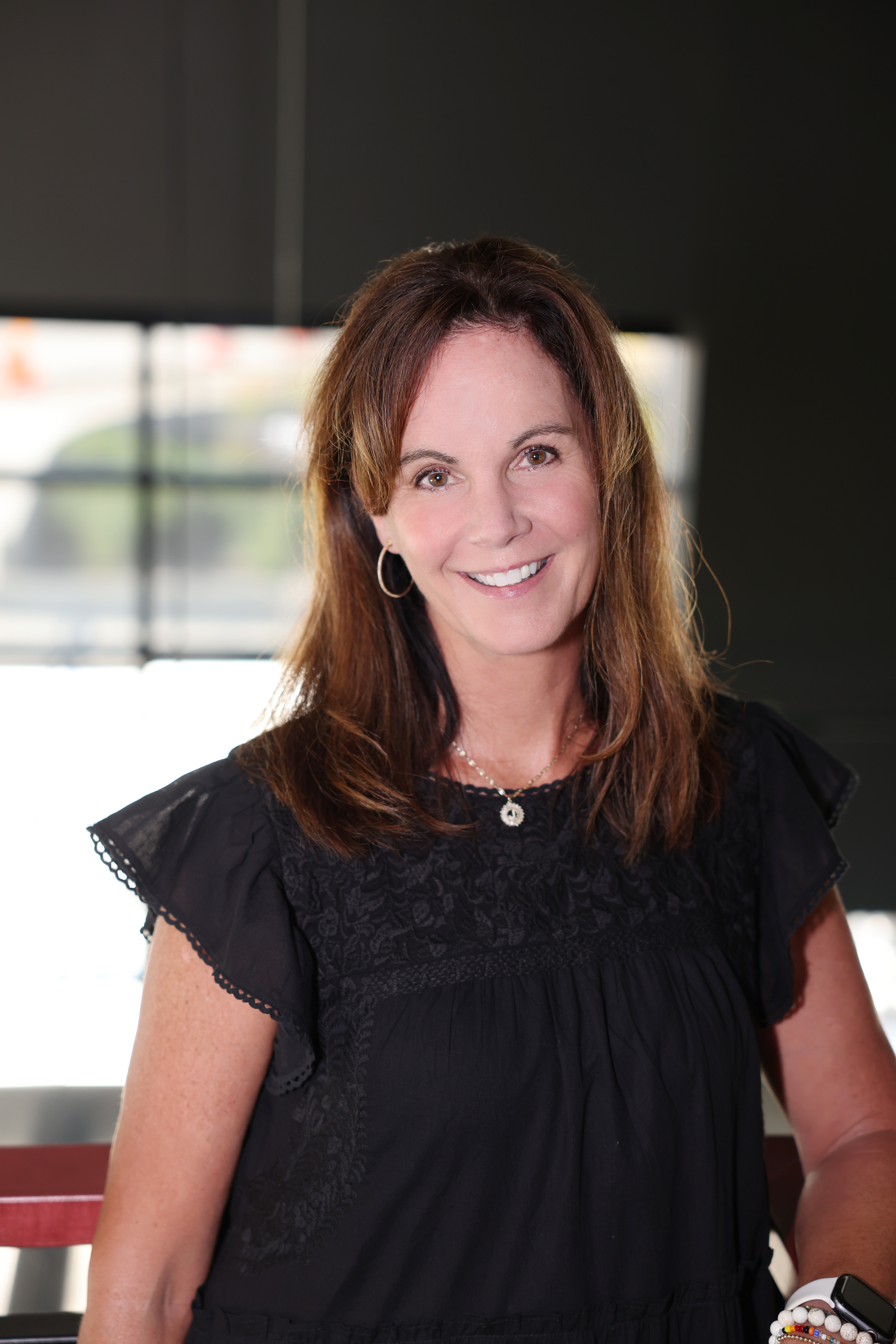 Julie Robbins Life Coach black dress portrait  bio photo Julie Robbins Certified Life Coach Certified 9D Breathwork Facilitator in Mequon, WI Bio photo in black dress giving a presentation